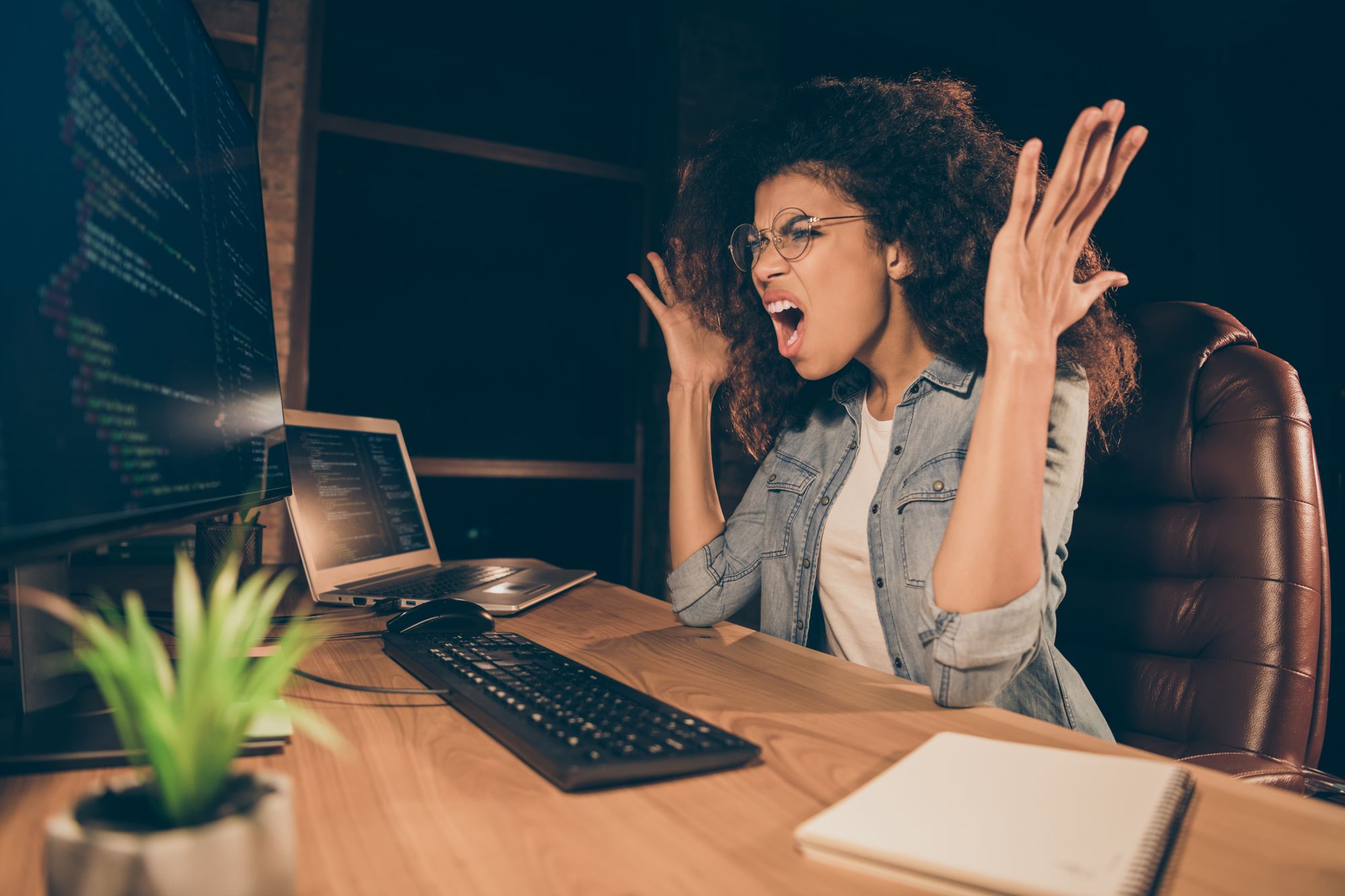 Photo of software developer screaming at her computer